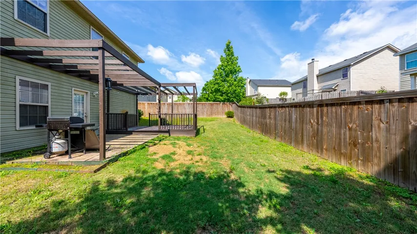 This spacious yard offers a deck, perfect for outdoor entertaining and enjoying the serene surroundings.