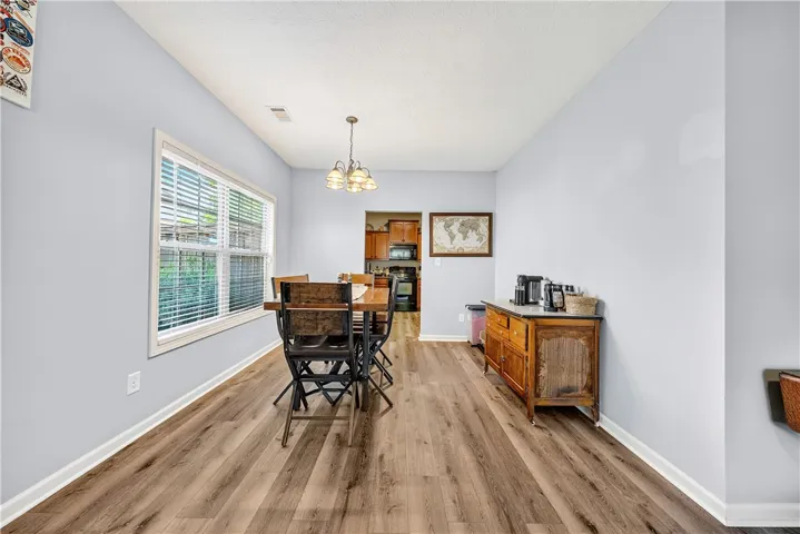 This dining area features durable flooring, offering a comfortable space for meals and gatherings.