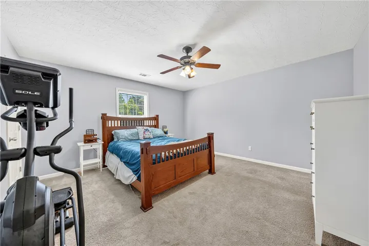 This spacious bedroom offers ample natural light and a serene ambiance.