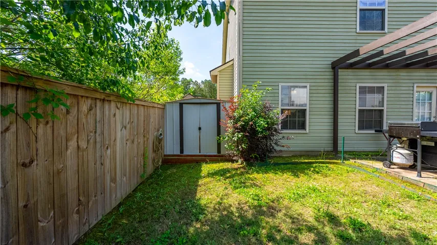 This private yard offers outdoor storage and a charming patio area.
