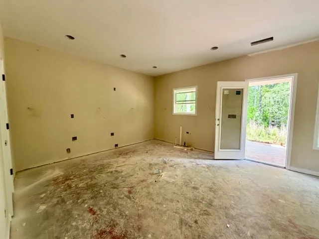 This versatile room offers potential for diverse living arrangements and features convenient outdoor access.