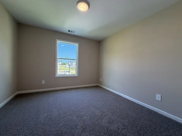 A well-lit room with ample space for relaxation.