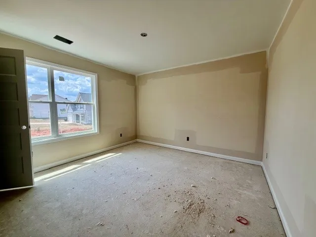 This versatile room offers ample space, bathed in natural light, awaiting your personal touch.