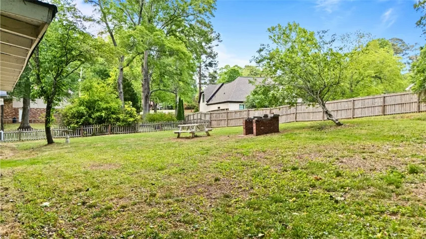 This verdant outdoor space offers a private retreat with ample room for leisure and entertaining.