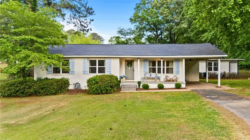 This charming home offers a lovely front porch and convenient carport.