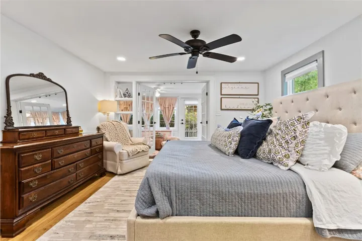 This spacious bedroom offers comfortable living with elegant design and natural light.