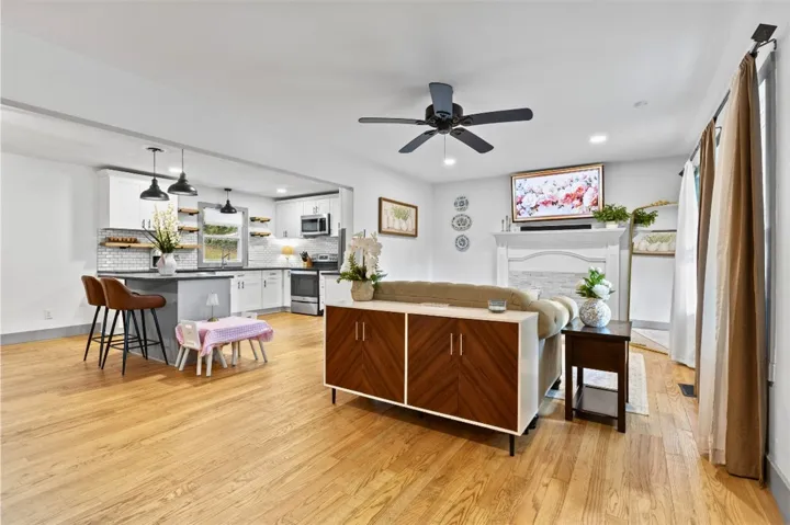 This inviting space features an open layout connecting the kitchen and living areas, perfect for daily living.