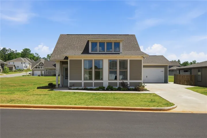 This charming home offers a welcoming facade with inviting curb appeal and an attached garage.