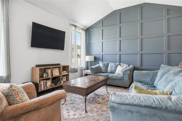 A vaulted ceiling, custom millwork, and a punch of color provide this gathering space a desireable backdrop.