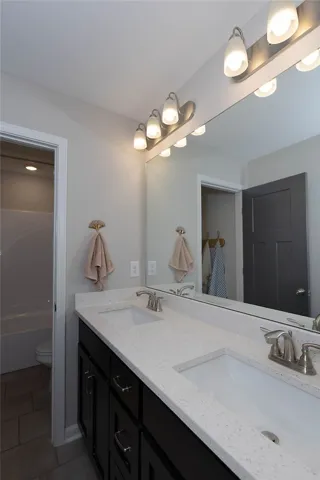 This bathroom features a double vanity with ample counter space.