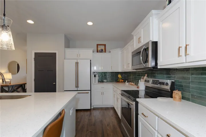 This luminous kitchen features modern appliances and elegant countertops.