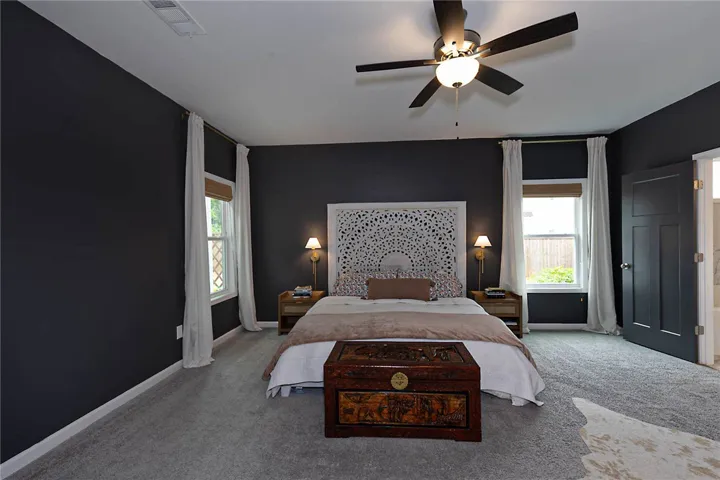 This restful bedroom features plush carpeting and abundant natural light.