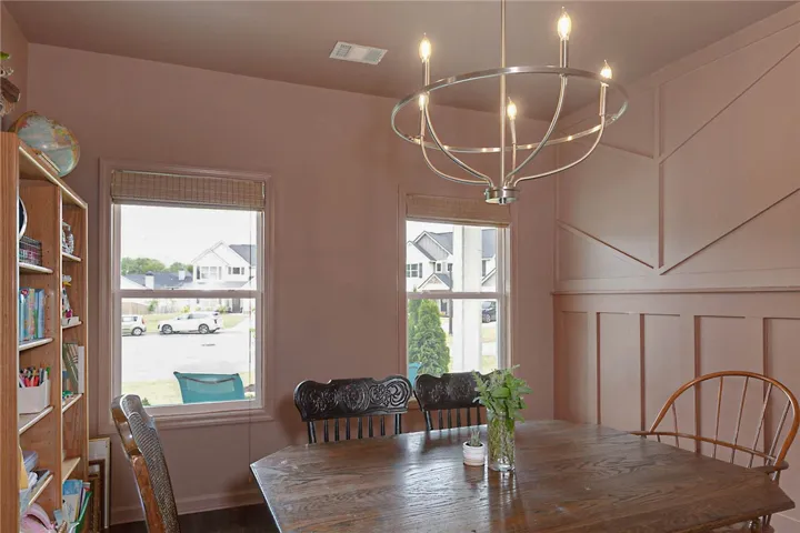 This dining area features elegant wall molding and a stylish chandelier, perfect for memorable gatherings.