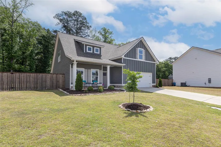This charming home offers a welcoming facade with a cozy front porch and a well-maintained lawn.