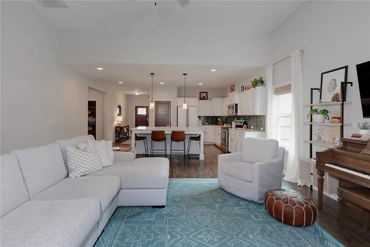 This inviting space seamlessly connects a modern kitchen and a comfortable living area, ideal for daily life.