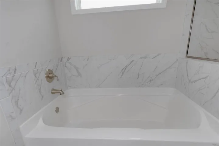 This serene bathroom offers a luxurious soaking tub for ultimate relaxation.