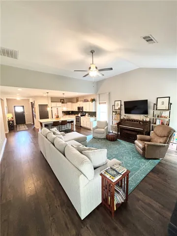 An inviting open-concept space features rich wood flooring and abundant natural light.