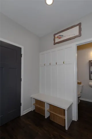 This inviting entryway features convenient built-in storage and durable wood flooring.