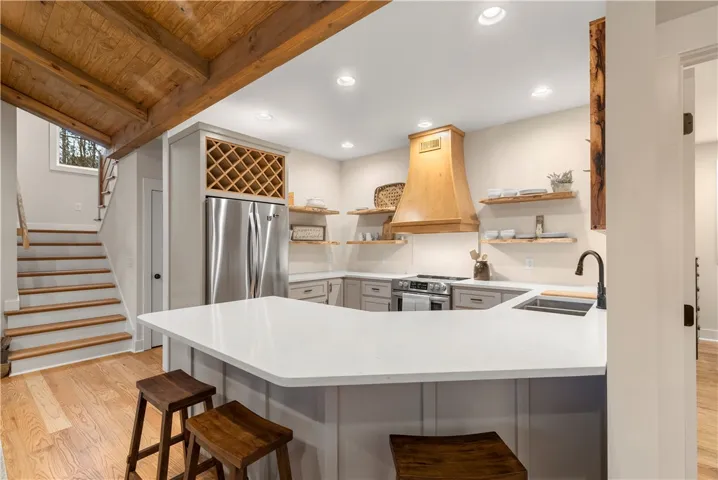 This modern kitchen features warm wood accents and stainless steel appliances, creating an inviting culinary space.