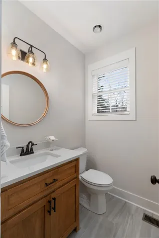 This bright bathroom features a modern vanity and elegant tile flooring.