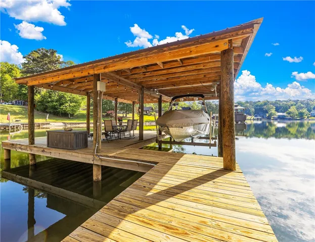 This tranquil waterfront dock features a covered boat slip and boat lift