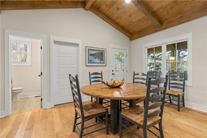 The dining area features warm wood accents and abundant natural light.