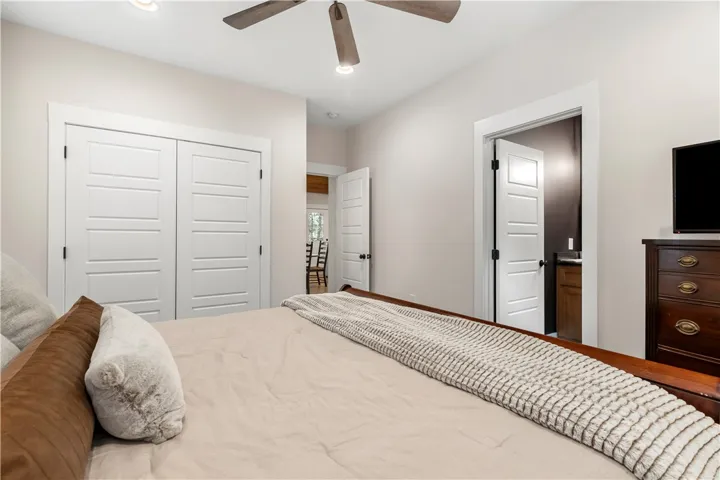 This spacious bedroom offers ample storage and a private en-suite bathroom.
