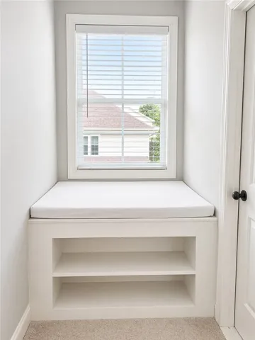 This cozy window nook with integrated storage offers a peaceful retreat.