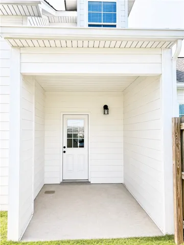 This inviting back patio provides shade, privacy and a tranquil outdoor retreat.