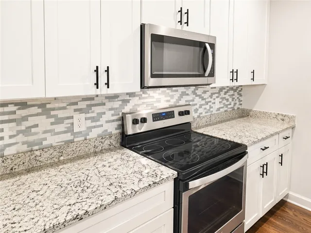 This bright kitchen features sleek appliances, ample counter space, and modern cabinetry.