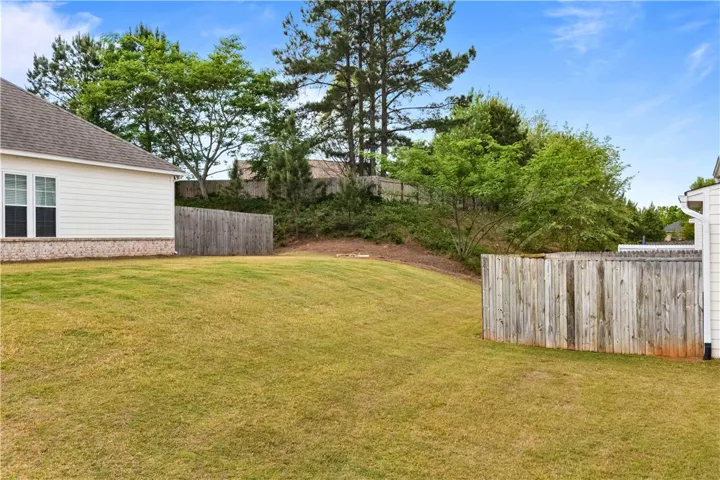 This spacious backyard offers privacy and room for outdoor enjoyment.