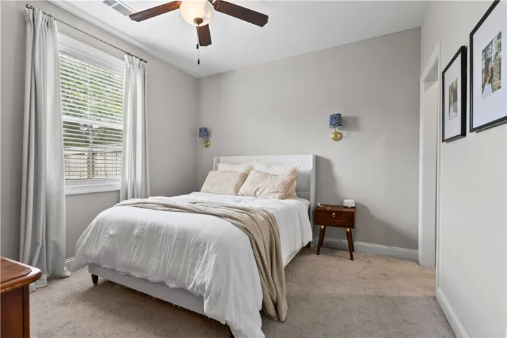 This inviting bedroom features soft lighting and ample space for restful living.