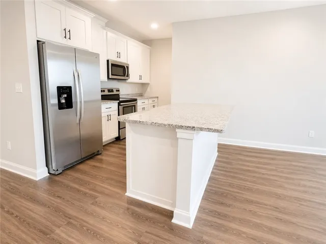 This bright kitchen features modern appliances and an inviting kitchen island.