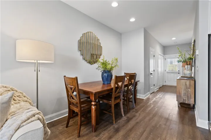 This inviting dining area features elegant flooring and bright recessed lighting.
