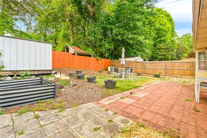 Brick patio and privacy fencing.