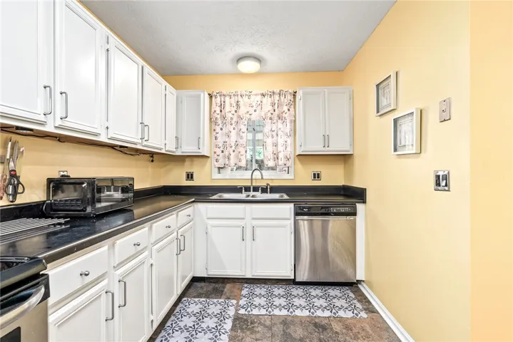 This bright kitchen features ample cabinetry and modern appliances, creating a highly functional culinary space.