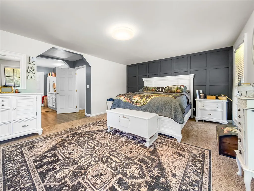 This spacious bedroom offers a tranquil retreat with ample natural light.