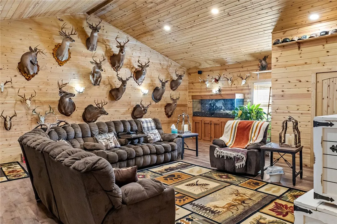 Warm wood paneling and vaulted ceilings define this inviting living space.