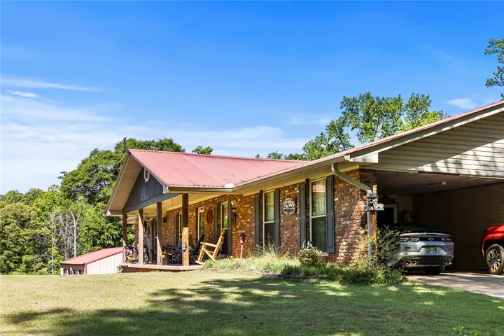 This charming home offers a spacious porch and ample outdoor space, perfect for enjoying the surroundings.