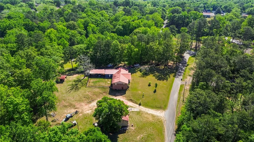 Nestled amidst lush greenery, this property offers a peaceful escape with expansive grounds.