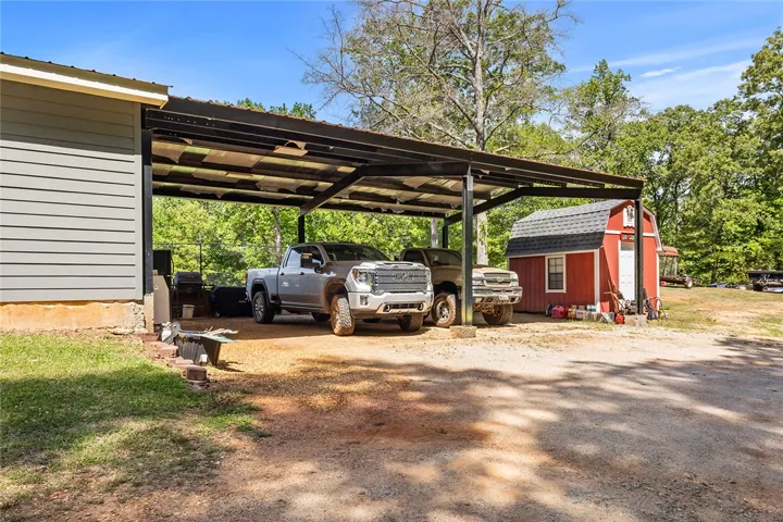 This property features ample covered parking and a charming shed, perfect for additional storage.