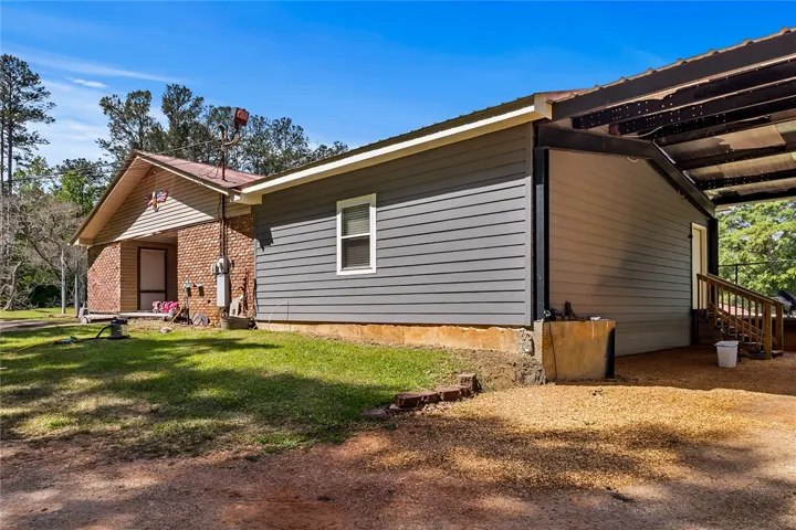 This charming home features a combination of classic brick and modern siding, offering a unique architectural appeal.