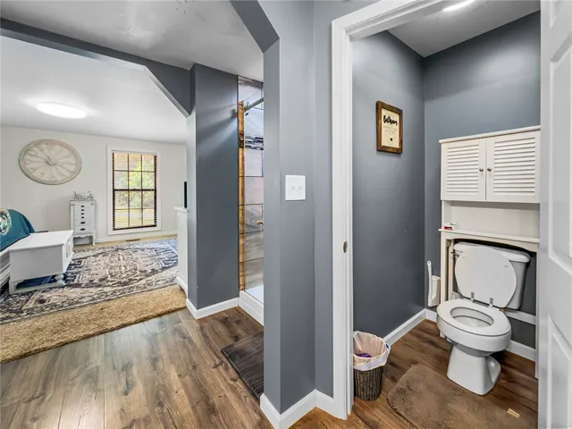This interior image showcases an elegant bathroom with wood flooring and natural lighting.