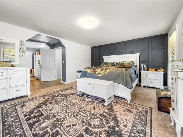 This spacious bedroom offers a tranquil retreat with ample natural light.