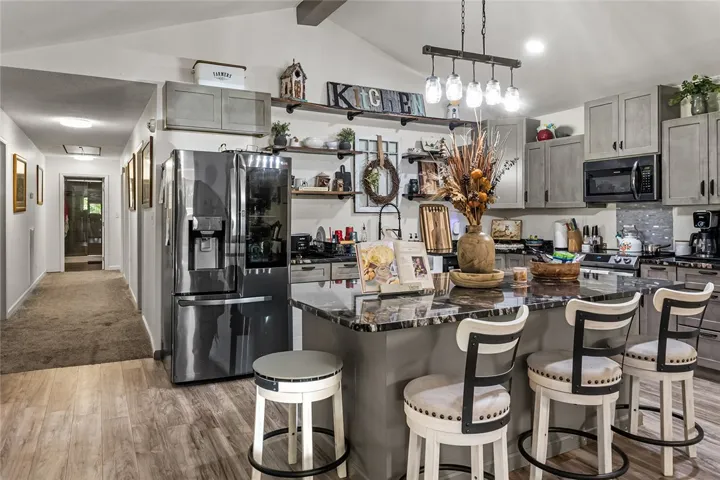 This spacious kitchen offers a beautiful island with seating, ideal for entertaining and daily living.