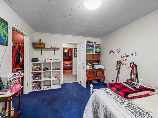 This cozy bedroom features plush carpet, offering a comfortable retreat for rest and relaxation.