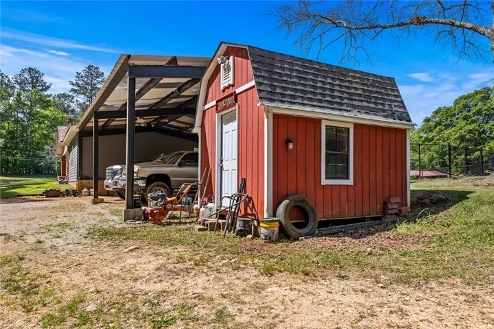 This property features a charming shed and a practical carport.