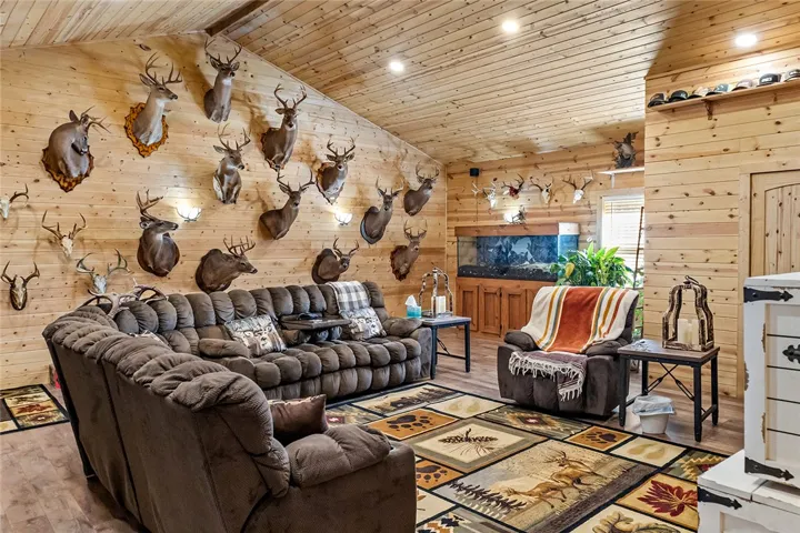 Warm wood paneling and vaulted ceilings define this inviting living space.