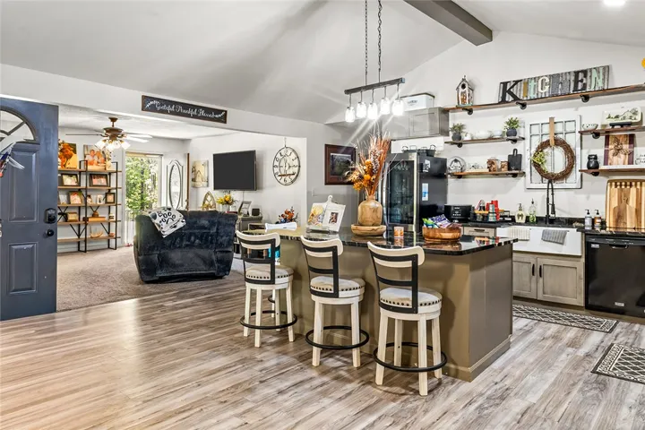 This open concept space features a kitchen island and high ceilings, perfect for modern living.