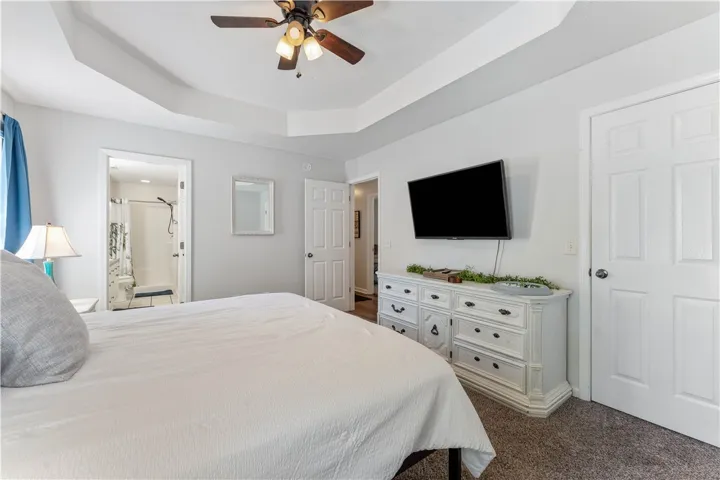 This spacious primary bedroom offers comfort and direct access to a private bathroom.